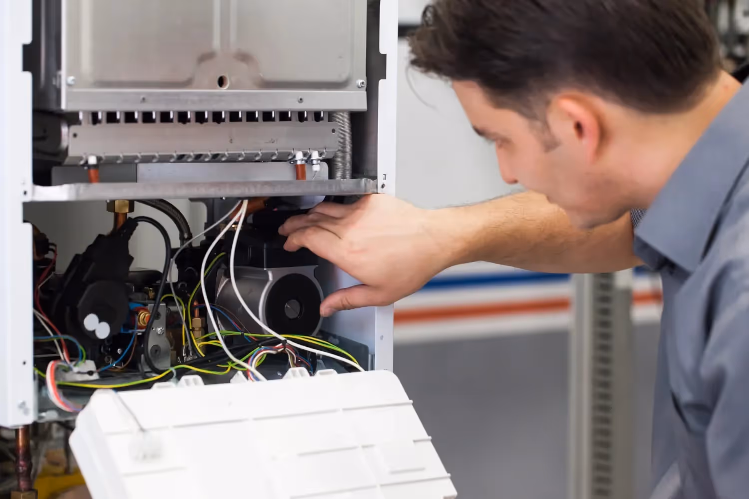 Patriot technician carrying out furnace repair in a Fenton home