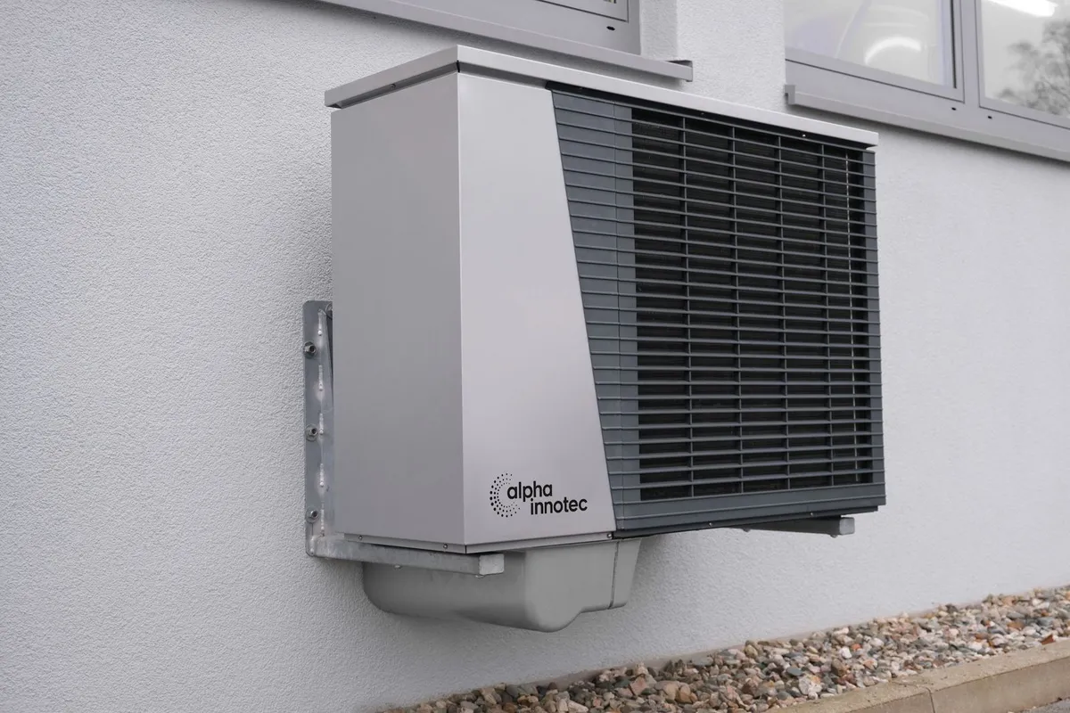 Newly installed outdoor air conditioning unit mounted on a house exterior