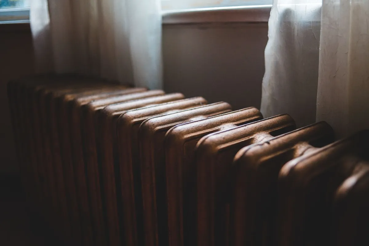 Cast-iron radiator beneath a window in a home