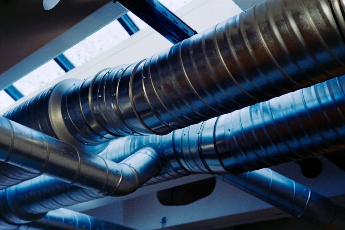 Spiral metal ducts running beneath a skylight